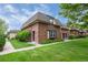 Charming brick townhouse with well-manicured lawn and mature landscaping, creating a welcoming curb appeal at 5547 S Lowell Blvd, Littleton, CO 80123