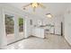 Kitchen with white cabinets, tiled floor and access to backyard at 5547 S Lowell Blvd, Littleton, CO 80123