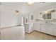 Kitchen with white cabinets, tiled floors and access to backyard at 5547 S Lowell Blvd, Littleton, CO 80123