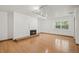 Bright living room with hardwood floors, fireplace, and large window at 5547 S Lowell Blvd, Littleton, CO 80123