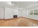 Bright living room with hardwood floors, fireplace, and large window at 5547 S Lowell Blvd, Littleton, CO 80123