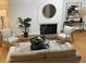 Bright living room featuring modern decor, a cozy fireplace, and stylish furnishings for comfortable living at 5547 S Lowell Blvd, Littleton, CO 80123