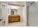 Bright bathroom featuring a double vanity with a granite countertop and a glass-enclosed shower at 11213 Vilas St, Parker, CO 80134