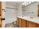 Bathroom features a double sink vanity, a tub/shower combo, and vinyl floors at 11213 Vilas St, Parker, CO 80134