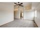 Open bedroom with large window, ceiling fan and entrance to the attached bathroom at 11213 Vilas St, Parker, CO 80134