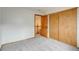 Bright bedroom features neutral carpet, closet with sliding doors and door to hallway at 11213 Vilas St, Parker, CO 80134