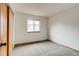 Clean bedroom featuring neutral carpet, window and closet with sliding doors at 11213 Vilas St, Parker, CO 80134