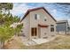 Rear view of home featuring neutral siding, red trim, patio and yard at 11213 Vilas St, Parker, CO 80134