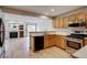 Modern kitchen with stainless steel appliances, hardwood floors, and oak cabinets at 11213 Vilas St, Parker, CO 80134