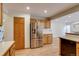 Bright kitchen features stainless steel refrigerator, wood cabinets, and hardwood flooring at 11213 Vilas St, Parker, CO 80134