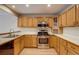 Modern kitchen with stainless steel appliances, hardwood floors, and oak cabinets at 11213 Vilas St, Parker, CO 80134