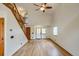 Open-concept living room features hardwood floors, stairs, and a ceiling fan at 11213 Vilas St, Parker, CO 80134