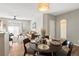 Bright dining area with a round table and four chairs, adjacent to living room and kitchen at 14343 E 1St Dr # 202, Aurora, CO 80011