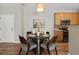 Dining area with a round table and four chairs, near entryway at 14343 E 1St Dr # 202, Aurora, CO 80011