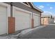 Attached garage with white doors and brick facade at 14343 E 1St Dr # 202, Aurora, CO 80011