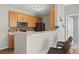 Kitchen features wood cabinets, stainless steel appliances, and a breakfast bar at 14343 E 1St Dr # 202, Aurora, CO 80011