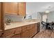 Modern kitchen with wood cabinets, stainless steel appliances, and a double sink at 14343 E 1St Dr # 202, Aurora, CO 80011