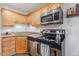 Well-equipped kitchen with stainless steel appliances, granite countertops, and white tile backsplash at 1885 S Quebec Way # C15, Denver, CO 80231