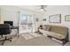 Neutral room with carpet, desk and a sliding door leading to the deck. Futon for seating at 1885 S Quebec Way # C15, Denver, CO 80231