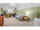 Cozy living room with neutral paint, carpet, accent wall, sofa and desk at 1885 S Quebec Way # C15, Denver, CO 80231