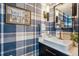 Stylish powder room featuring designer wallpaper, modern fixtures, and a marble countertop at 8735 W Cornell Ave # 7, Lakewood, CO 80227