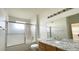 Clean bathroom includes a shower over tub, granite countertop and large mirror at 14333 E 1St Dr # 108, Aurora, CO 80011