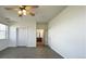 Bright and airy bedroom shows hardwood floors, ceiling fan, and view to attached bathroom at 14333 E 1St Dr # 108, Aurora, CO 80011