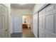 Hallway leading to the bathroom with tile flooring and storage closet at 14333 E 1St Dr # 108, Aurora, CO 80011