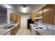 Galley kitchen with granite countertops, tile flooring, and lots of cabinet space at 14333 E 1St Dr # 108, Aurora, CO 80011