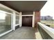 Covered outdoor patio with sliding glass doors and brick accents, offering a relaxing space and neighborhood views at 14333 E 1St Dr # 108, Aurora, CO 80011