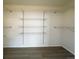 Spacious walk-in closet with adjustable metal shelving and wood-look flooring, ready for ample storage at 14333 E 1St Dr # 108, Aurora, CO 80011