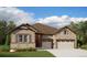 Charming single-Gathering home featuring stone accents and a two-car garage with a well-manicured lawn at 4975 Hickory Oaks St, Castle Rock, CO 80104