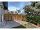 Secluded back patio enclosed by a modern wood fence, providing privacy and a defined outdoor space at 180 Dover St, Lakewood, CO 80226