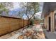 Spacious backyard with a decorative outdoor rug and wooden privacy fence, creating an inviting outdoor living space at 180 Dover St, Lakewood, CO 80226