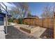 Landscaped backyard featuring a raised garden bed and wood privacy fence, ideal for gardening and outdoor enjoyment at 180 Dover St, Lakewood, CO 80226