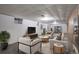Finished basement featuring plush carpet, modern furniture, and ample space for entertainment at 180 Dover St, Lakewood, CO 80226