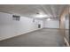 Large basement area features carpeted floors, white walls, and two small windows at 180 Dover St, Lakewood, CO 80226