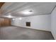 A finished basement with carpeted floors and some small windows for natural light at 180 Dover St, Lakewood, CO 80226