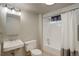 Bright bathroom with a shower-tub combo, modern vanity, and neutral color scheme at 180 Dover St, Lakewood, CO 80226