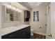 Stylish bathroom featuring a large vanity with marble countertop, new fixtures, and modern finishes at 180 Dover St, Lakewood, CO 80226