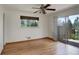 Bedroom with hardwood floors, window and sliding door access to outdoor patio at 180 Dover St, Lakewood, CO 80226