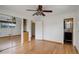 Bright bedroom featuring hardwood floors, mirrored closet, and ensuite bathroom at 180 Dover St, Lakewood, CO 80226