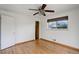 Bedroom boasts a ceiling fan, warm hardwood floors, and a large window at 180 Dover St, Lakewood, CO 80226