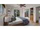 Bright bedroom featuring a ceiling fan, light-colored walls, and a glass sliding door with outdoor views at 180 Dover St, Lakewood, CO 80226