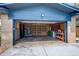 Open garage displaying ample storage space and a workbench, perfect for projects and organization at 180 Dover St, Lakewood, CO 80226