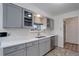 Contemporary kitchen with stainless steel appliances, light-gray cabinets, quartz counters and modern fixtures at 180 Dover St, Lakewood, CO 80226