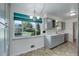 Bright kitchen features updated cabinets, stainless steel sink, a window view, and a modern light fixture at 180 Dover St, Lakewood, CO 80226