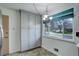 Well-lit kitchen area with pantry storage, a bright window view, and neutral decor at 180 Dover St, Lakewood, CO 80226