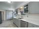 Updated kitchen with modern gray cabinets, stainless steel appliances, and quartz countertops at 180 Dover St, Lakewood, CO 80226