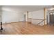 Spacious living room featuring hardwood floors, staircase, and front door entrance at 180 Dover St, Lakewood, CO 80226